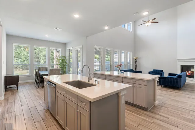 a kitchen with a sink and living room