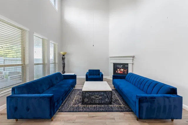 a living room with couch and a fireplace