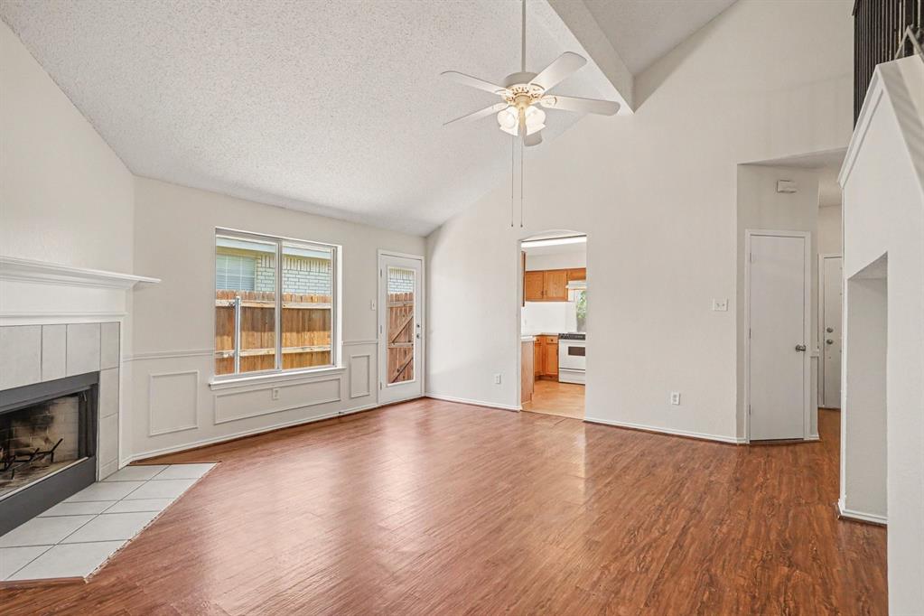 2541 Rivers Edge Drive Fort Worth, TX 76118 - Photo 5 of 31 an empty room with wooden floor fireplace and windows