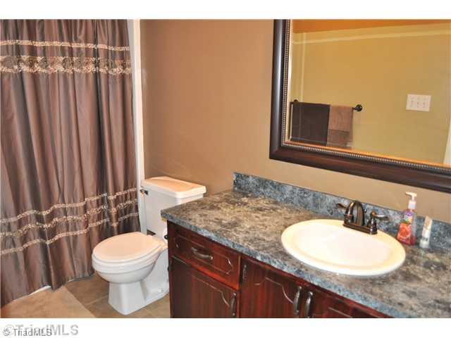 607 Silver Ridge Drive Lexington, NC 27292 - Photo 12 of 15 Bath. Recent updates include tile floor, fresh paint/stain, and faucet/hardware.