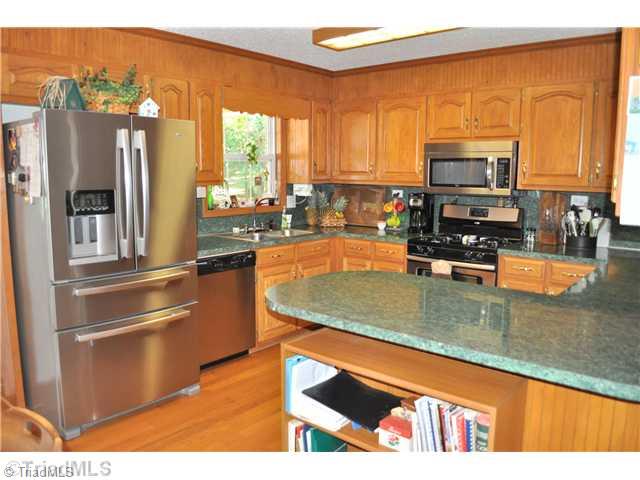 607 Silver Ridge Drive Lexington, NC 27292 - Photo 7 of 15 Kitchen. Updated kitchen has nice cabinets, hardwood floors, and upgraded appliances.
