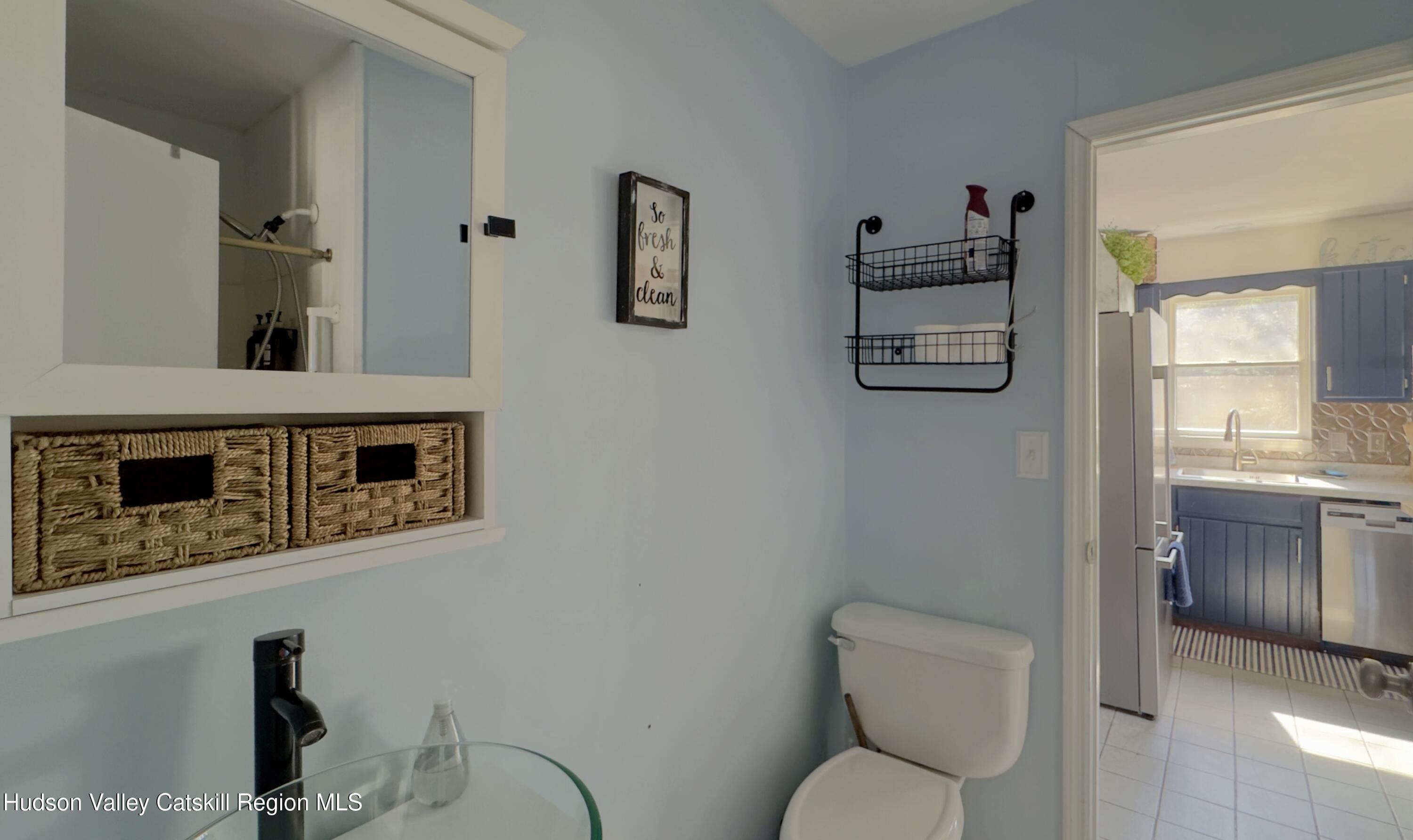 87 Sleepy Hollow Road Athens, NY 12015 - Photo 15 of 42 a bathroom with a toilet a sink and mirror
