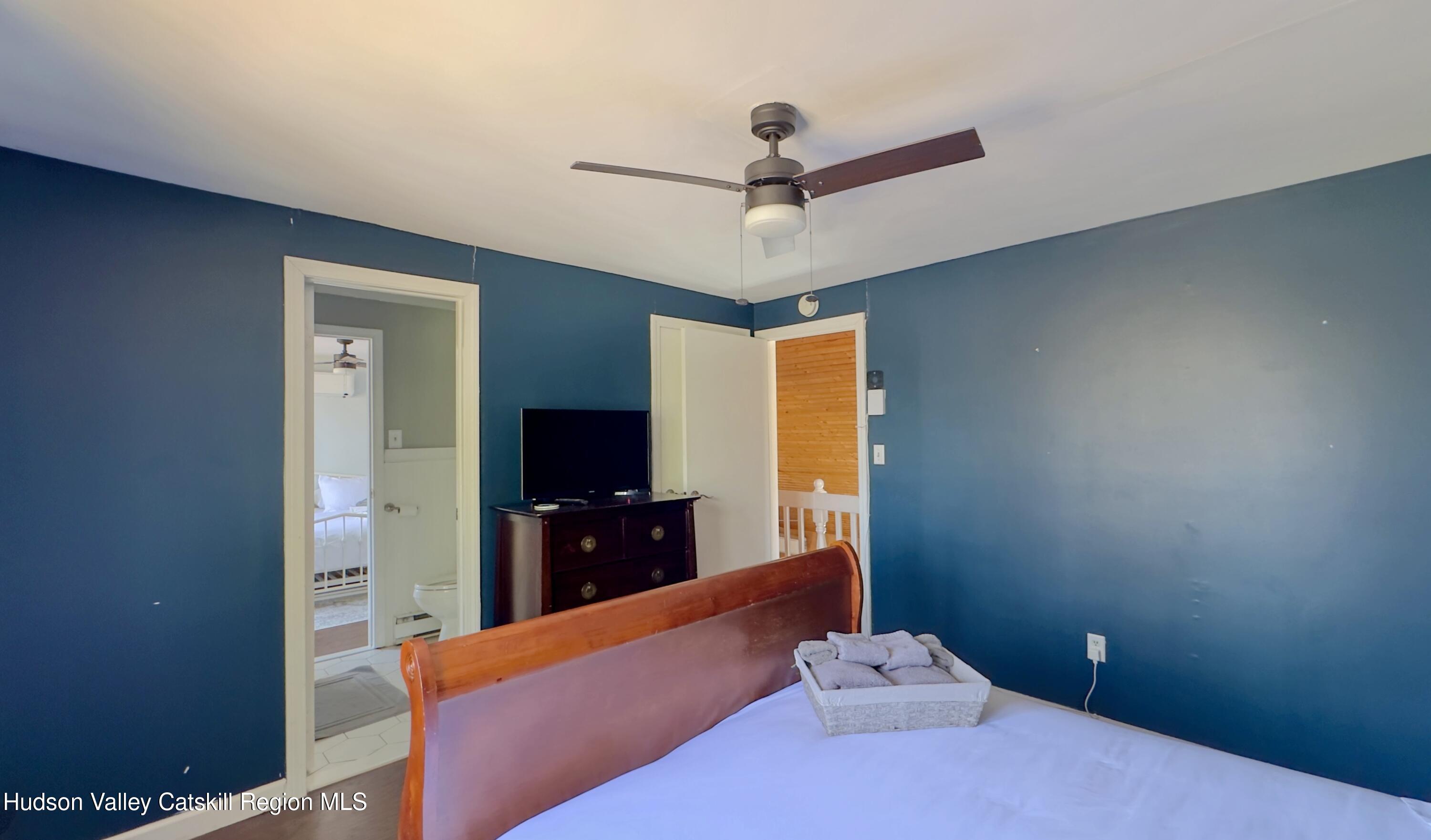 87 Sleepy Hollow Road Athens, NY 12015 - Photo 22 of 42 a bedroom with a bed and a flat screen tv