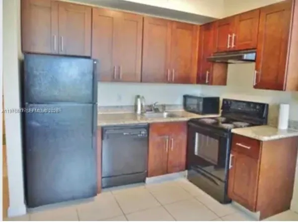 a kitchen with stainless steel appliances granite countertop a stove a refrigerator and a microwave