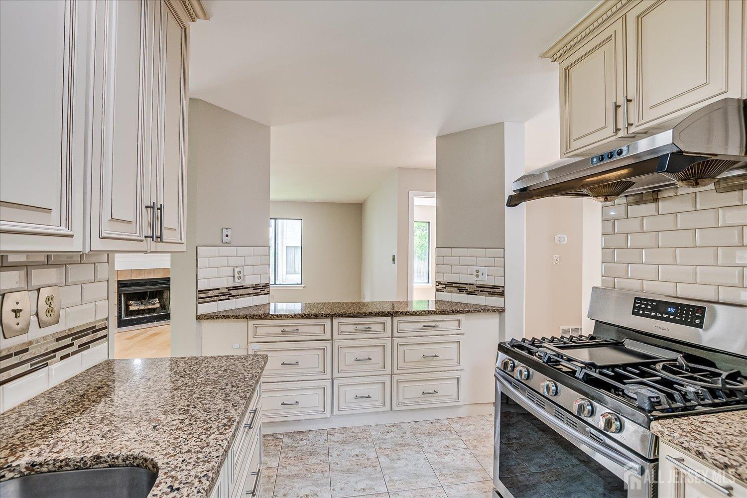 83 Park Gate Drive Edison, NJ 08820 - Photo 14 of 35 a kitchen with granite countertop a stove and a sink
