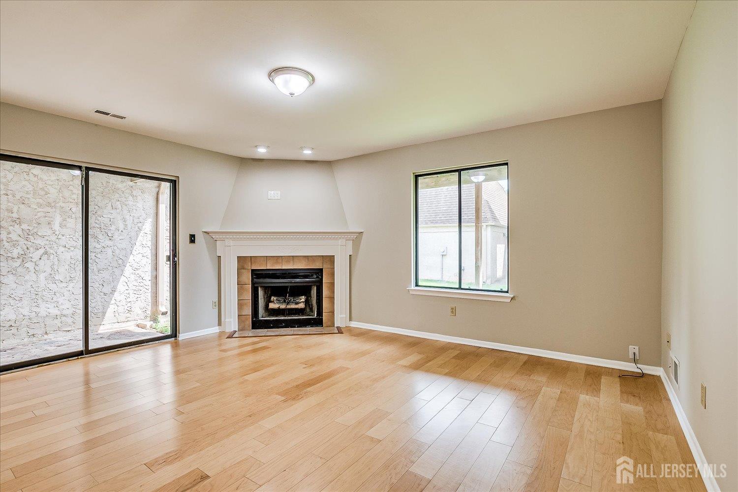 83 Park Gate Drive Edison, NJ 08820 - Photo 16 of 35 wooden floor fireplace and windows in an empty room