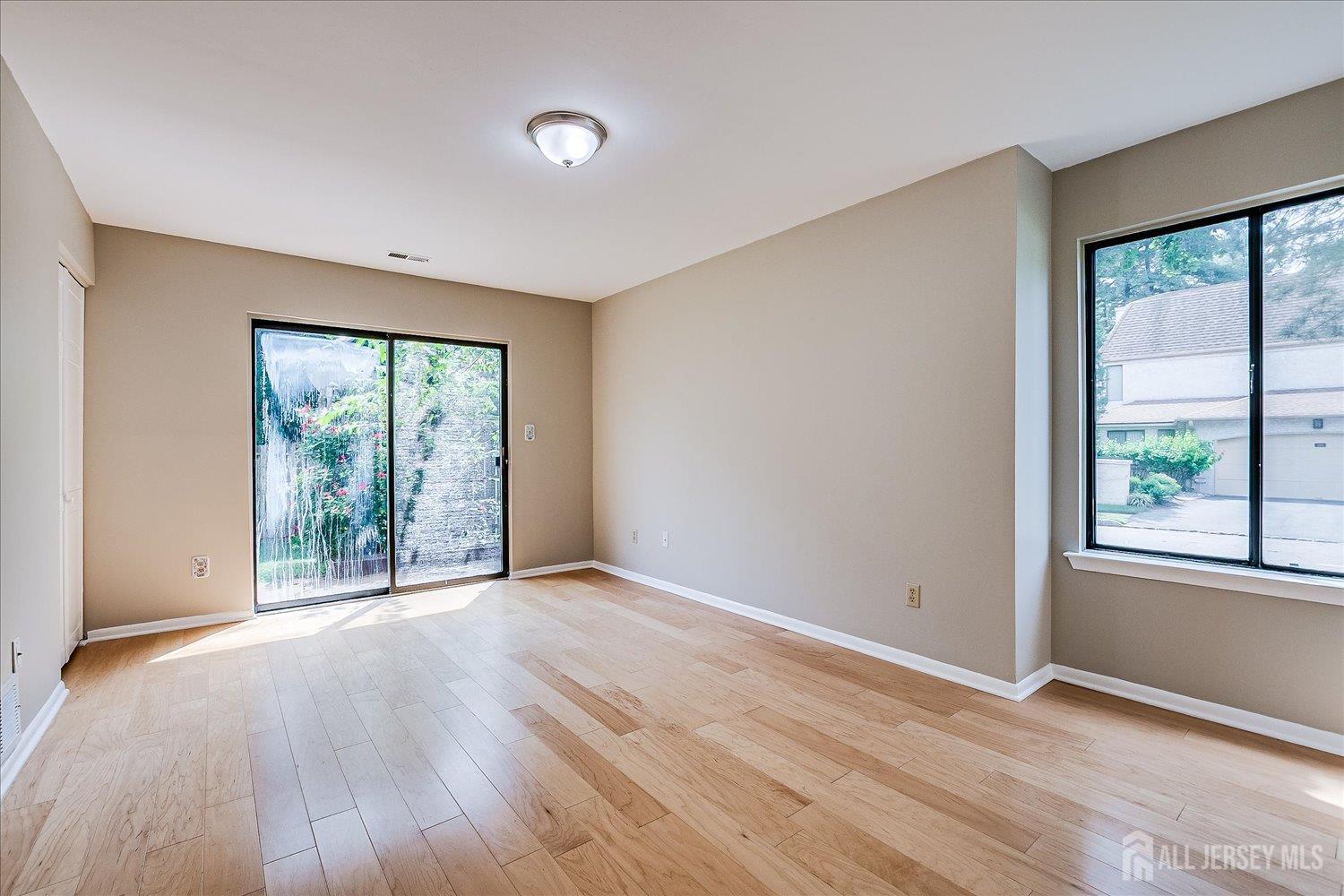 83 Park Gate Drive Edison, NJ 08820 - Photo 23 of 35 an empty room with wooden floor and windows