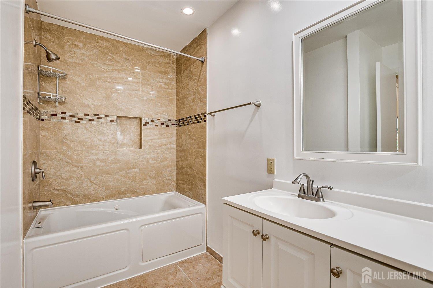 83 Park Gate Drive Edison, NJ 08820 - Photo 26 of 35 a bathroom with a granite countertop sink a mirror and a bathtub