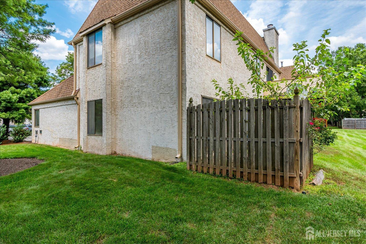 83 Park Gate Drive Edison, NJ 08820 - Photo 30 of 35 a view of backyard with potted plants and wooden fence