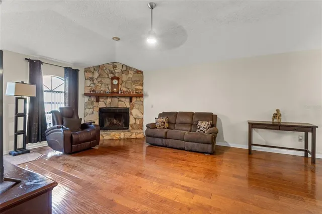 a living room with furniture and a fireplace