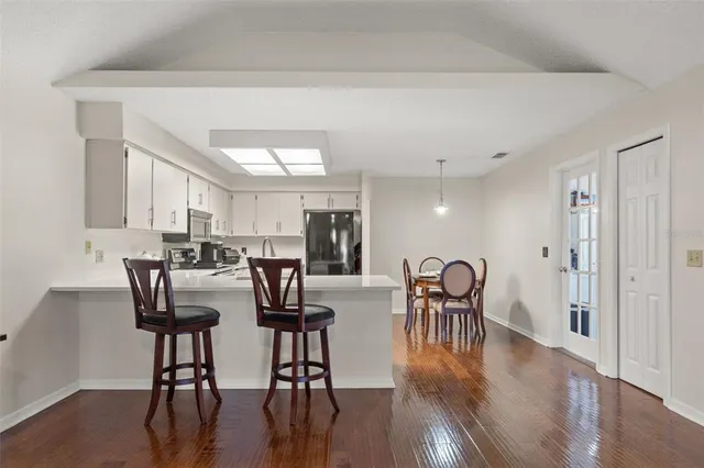 a view of a dining room with furniture and wooden floor