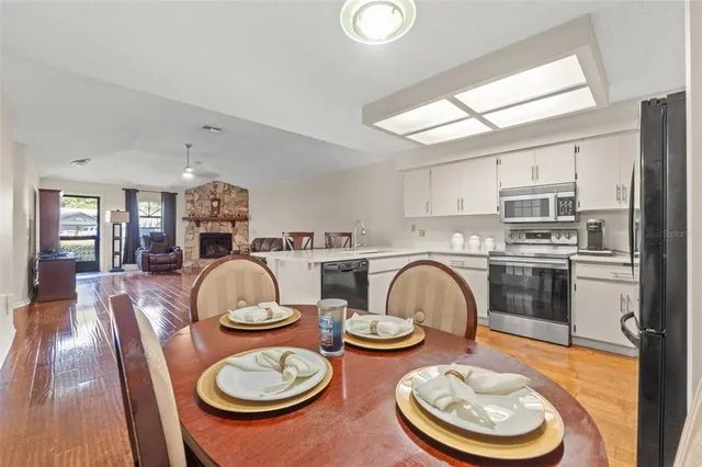 a kitchen with sink a stove and chairs