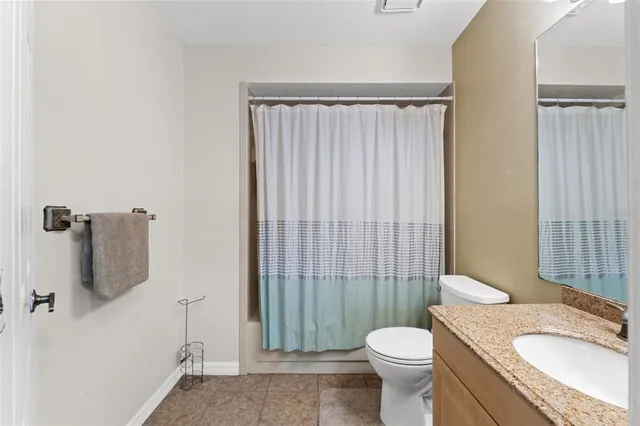 a white toilet sitting next to a bathroom sink