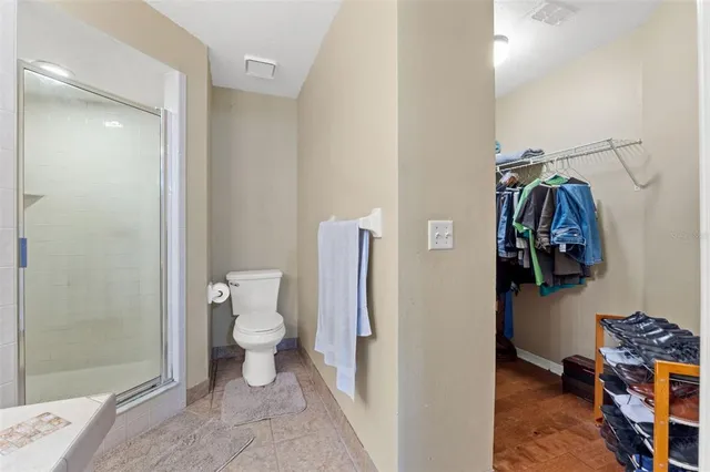 a bathroom with a toilet and a shower