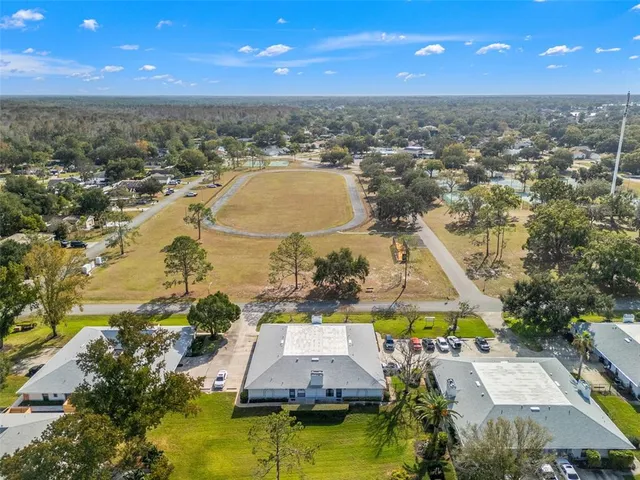 an aerial view of residential houses with outdoor space and swimming pool