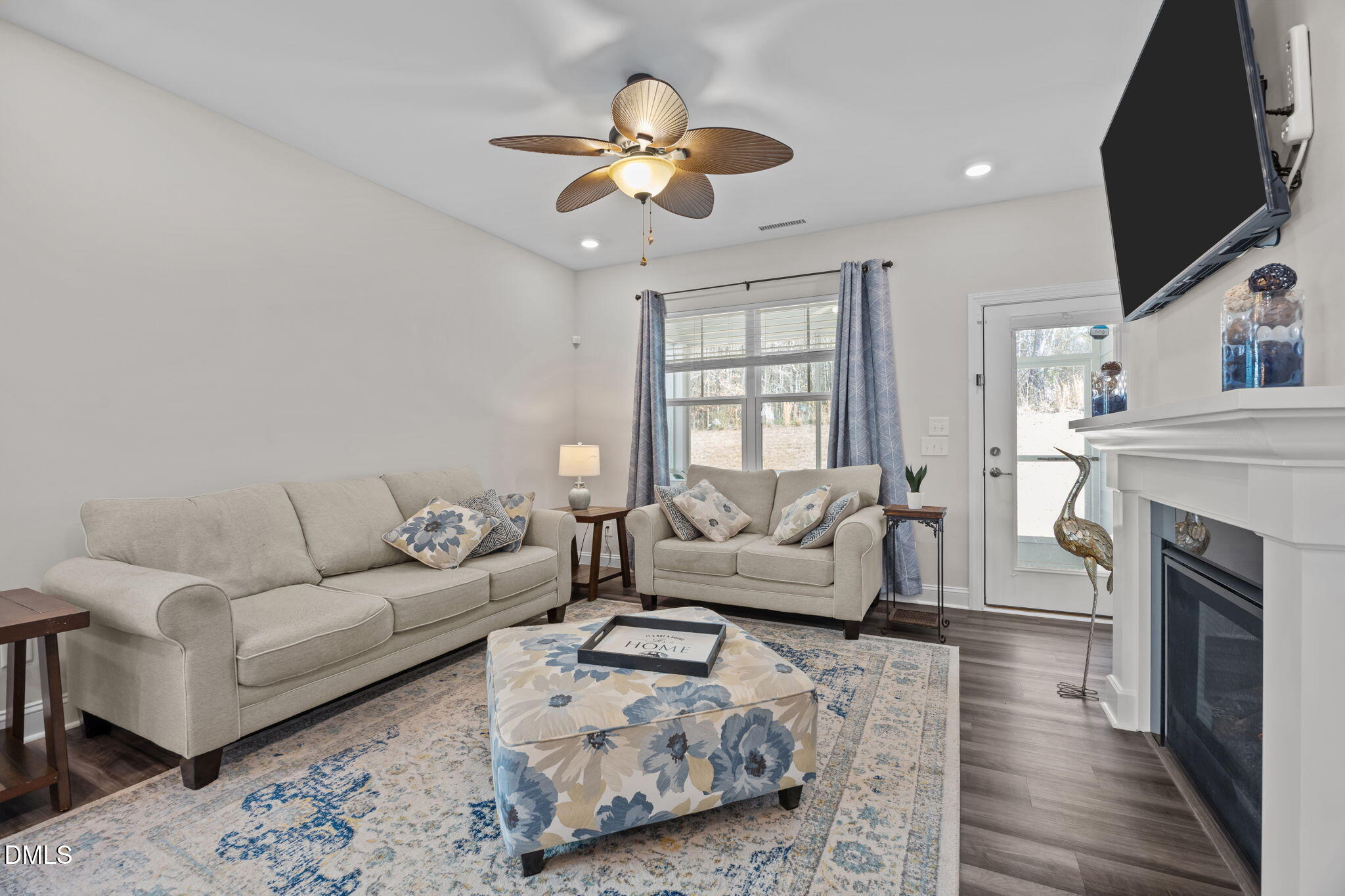 162 Desert Sand Lane Raleigh, NC 27610 - Photo 14 of 33 a living room with furniture a fireplace and a chandelier