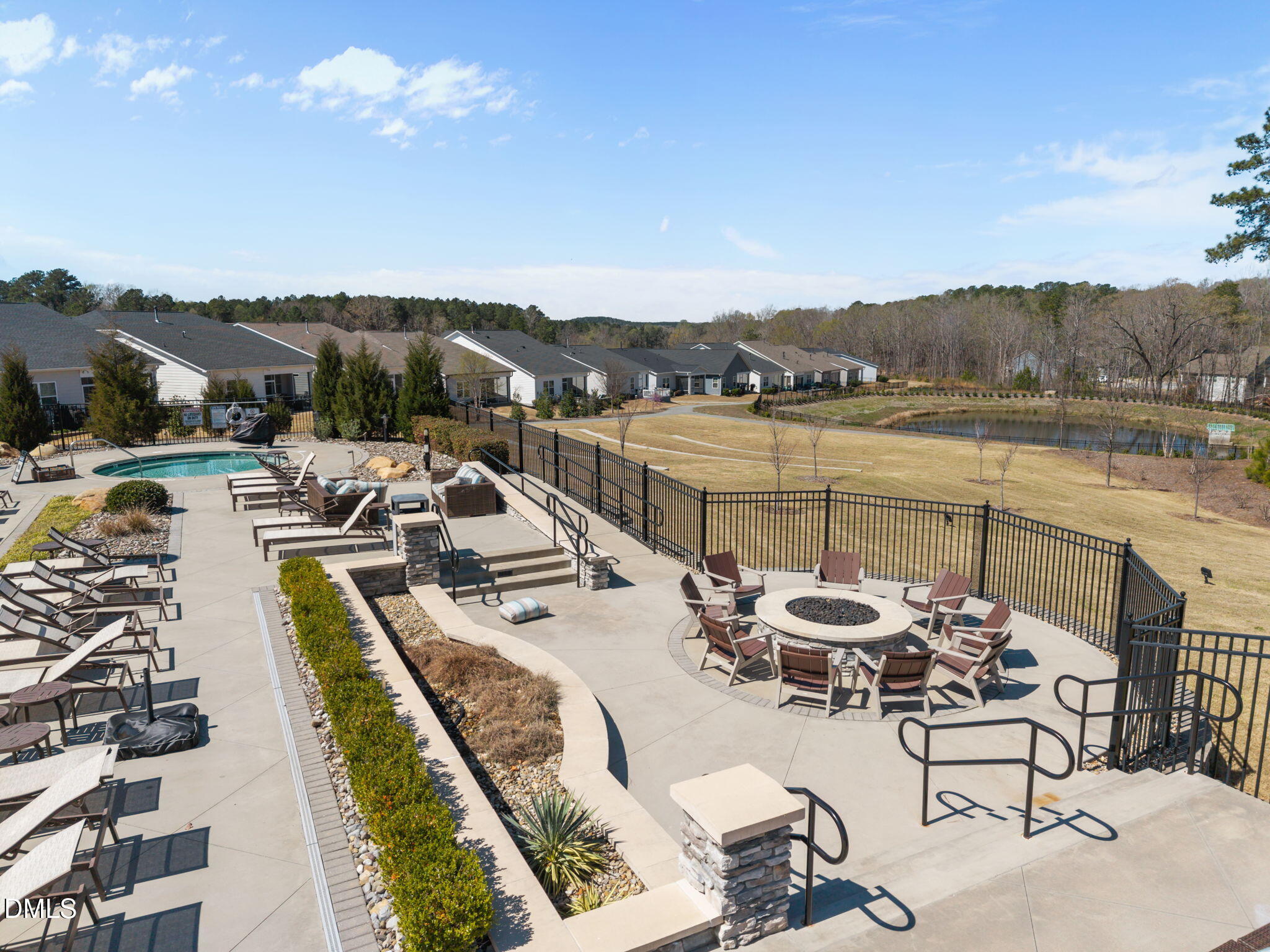 162 Desert Sand Lane Raleigh, NC 27610 - Photo 26 of 33 a view of a lake with couches chairs and swimming pool