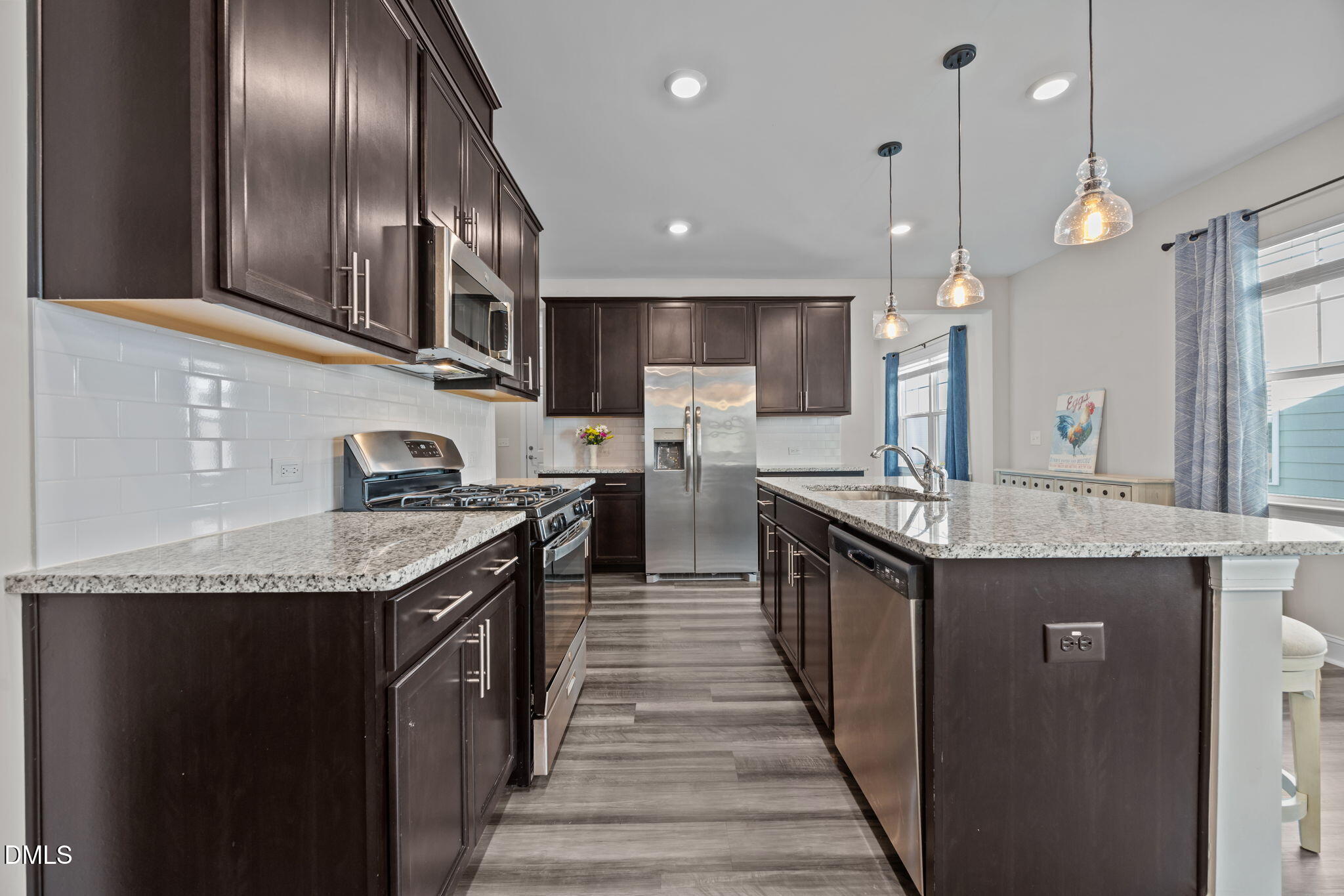 162 Desert Sand Lane Raleigh, NC 27610 - Photo 10 of 33 a kitchen with stainless steel appliances granite countertop plenty wooden cabinets