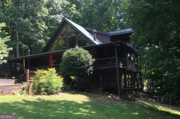 a kitchen with stainless steel appliances granite countertop a refrigerator a stove and a wooden floors