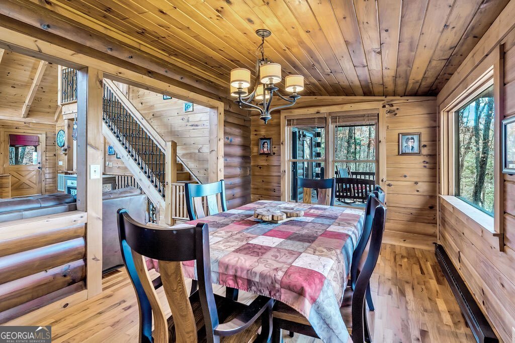 116 Channing Ridge Road, Unit 10 Morganton, GA 30560 - Photo 13 of 63 a dining room with furniture a chandelier and wooden floor