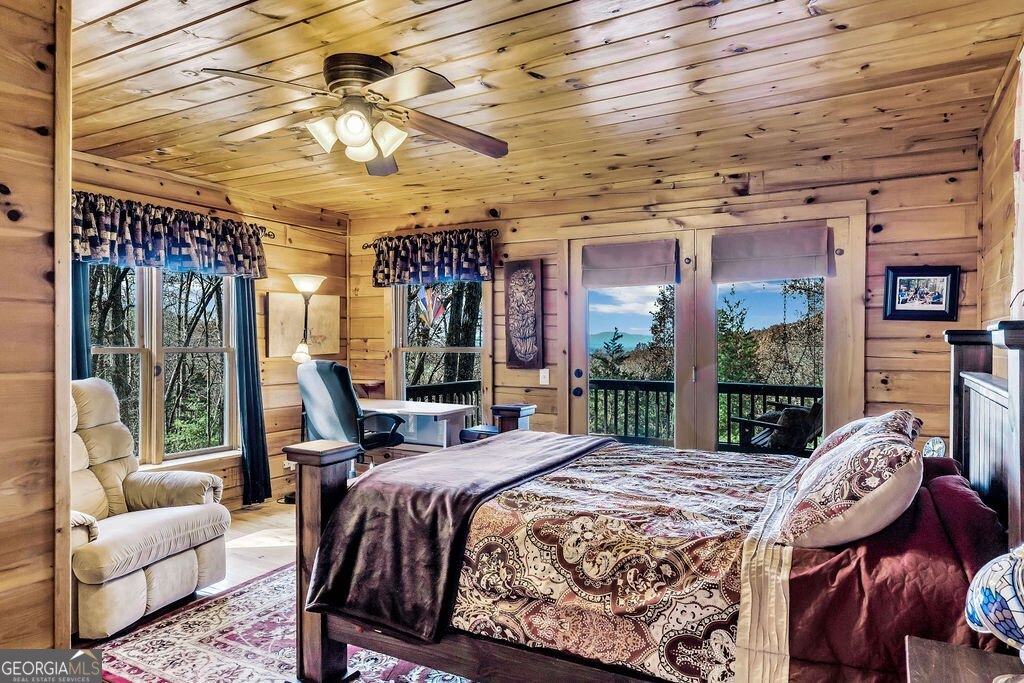 116 Channing Ridge Road, Unit 10 Morganton, GA 30560 - Photo 24 of 62 a bed sitting in a bedroom next to a large window