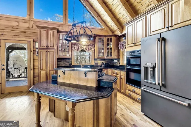 a living room with furniture a fireplace and kitchen view