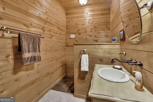 a backyard of a house with barbeque oven table and chairs