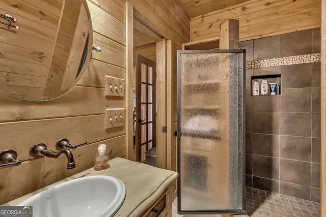 a view of a patio with table and chairs with wooden floor and fence