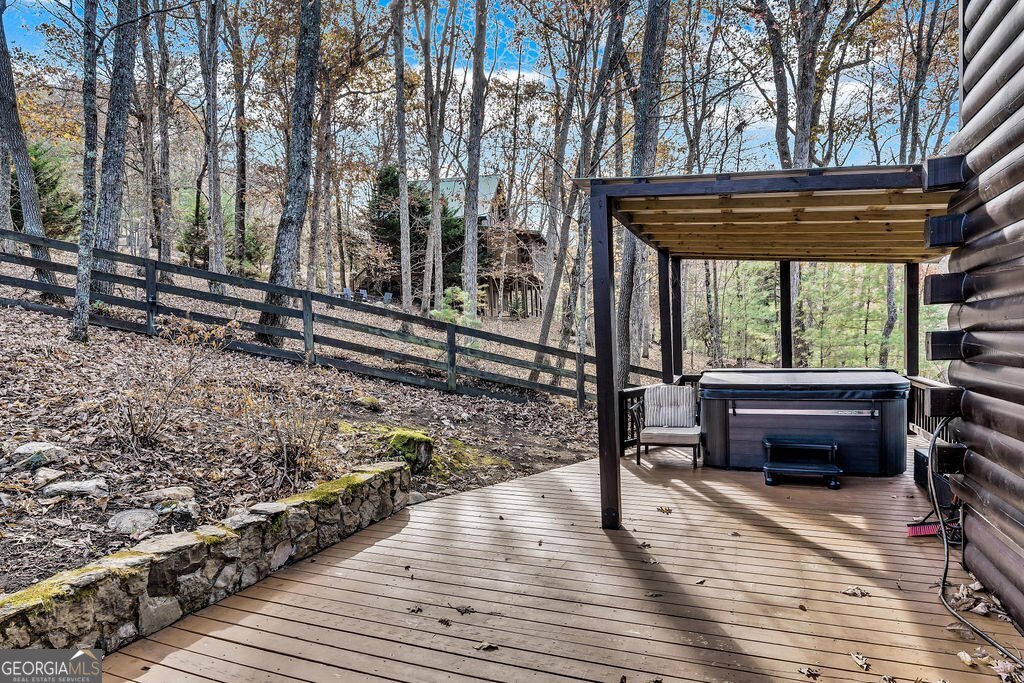 116 Channing Ridge Road, Unit 10 Morganton, GA 30560 - Photo 54 of 63 a backyard of a house with wooden floor outdoor seating and yard in the back