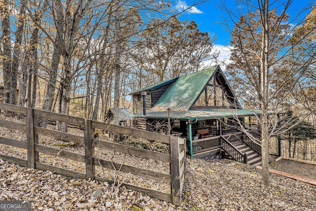116 Channing Ridge Road, Unit 10 Morganton, GA 30560 - Photo 57 of 62 a view of a house with wooden fence and a large tree