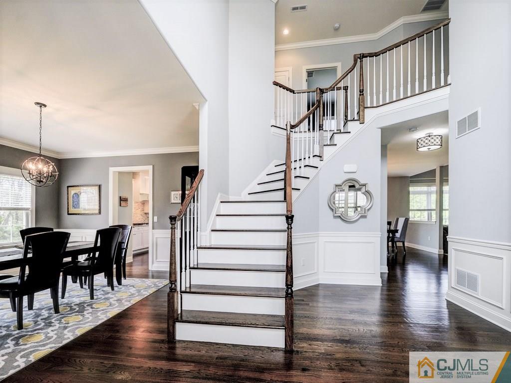 17 Thompson Grove Road Freehold, NJ 07728 - Photo 2 of 25 a view of a hallway with dining room and wooden floor