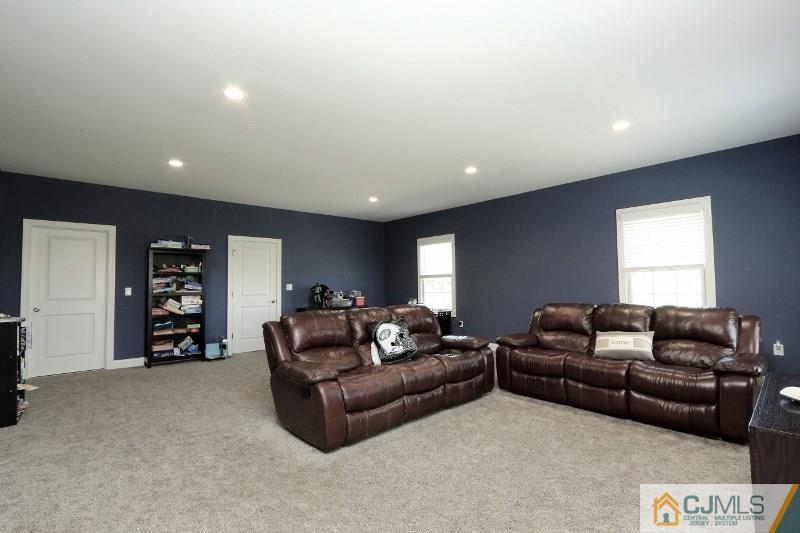 17 Thompson Grove Road Freehold, NJ 07728 - Photo 11 of 25 a living room with furniture and a flat screen tv