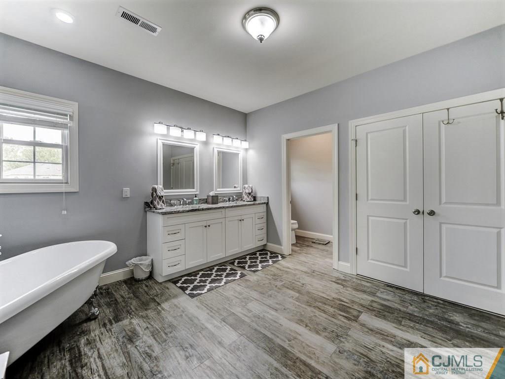 17 Thompson Grove Road Freehold, NJ 07728 - Photo 15 of 25 a bathroom with a sink and a mirror