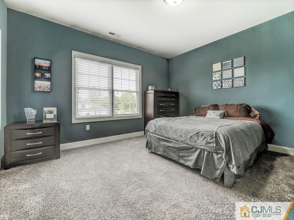 17 Thompson Grove Road Freehold, NJ 07728 - Photo 16 of 25 a bedroom with a bed and a window