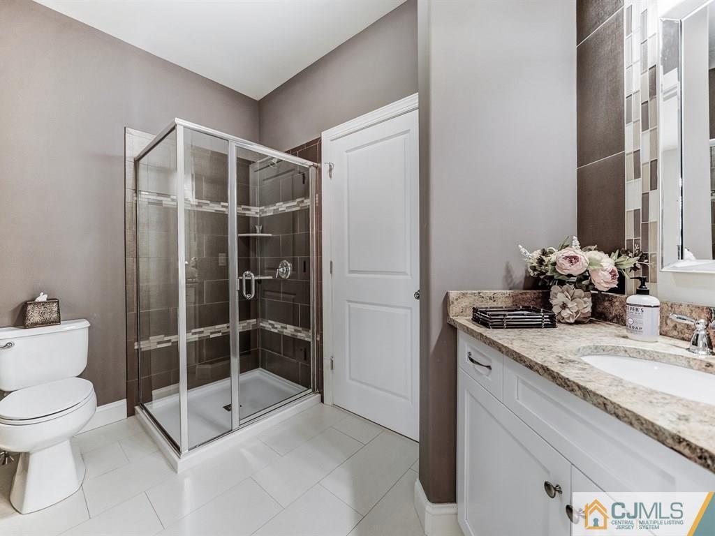 17 Thompson Grove Road Freehold, NJ 07728 - Photo 17 of 25 a bathroom with a granite countertop sink mirror and toilet