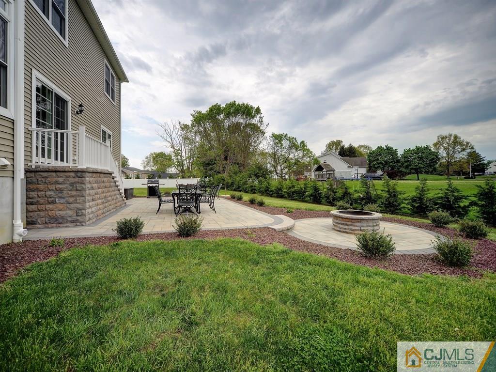17 Thompson Grove Road Freehold, NJ 07728 - Photo 23 of 25 a view of a patio with table and chairs and potted plants