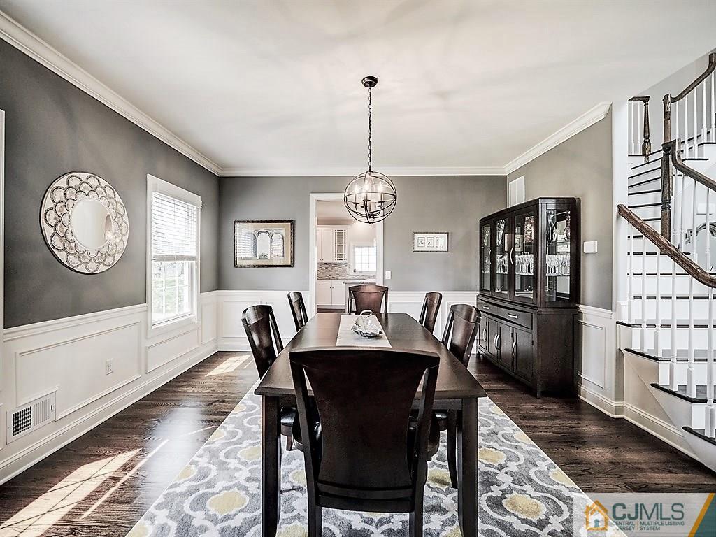 17 Thompson Grove Road Freehold, NJ 07728 - Photo 7 of 25 a dining room with furniture a rug and a chandelier