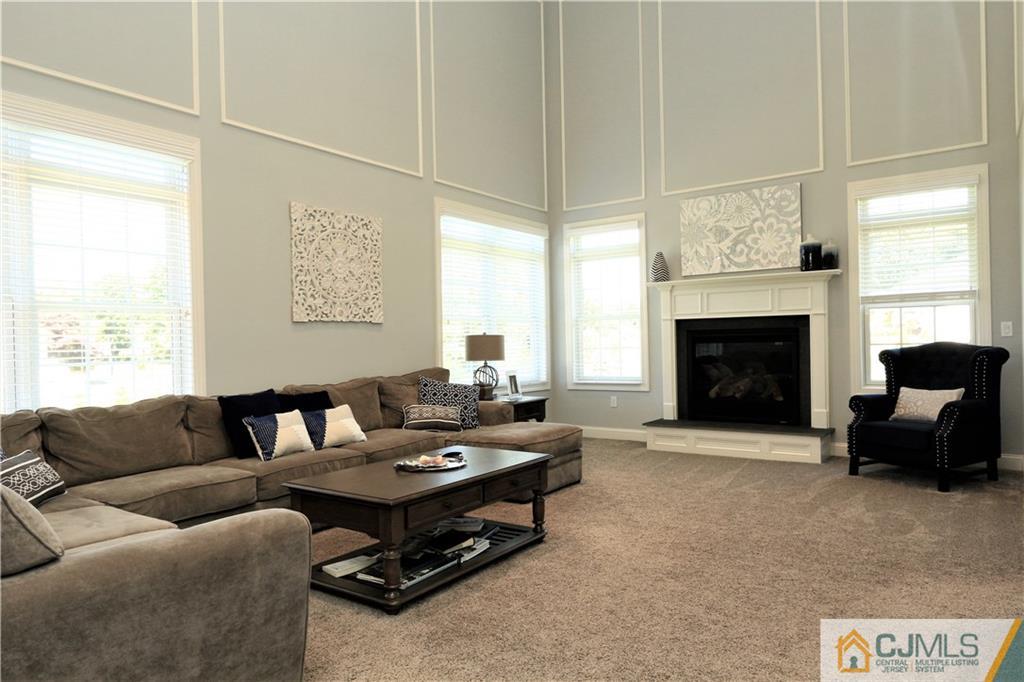 17 Thompson Grove Road Freehold, NJ 07728 - Photo 8 of 25 a living room with furniture window and a fireplace