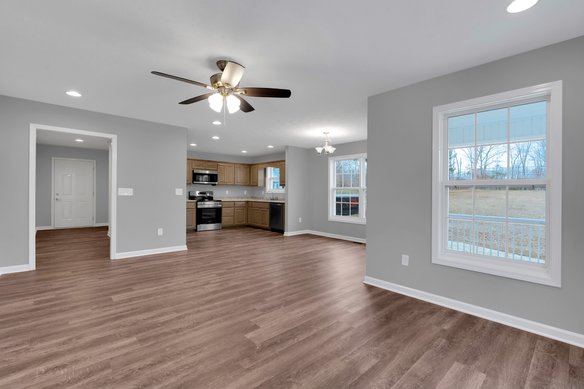 1332 Carter Blake Road Tullahoma, TN 37388 - Photo 6 of 31 a view of an empty room with a kitchen and wooden floor