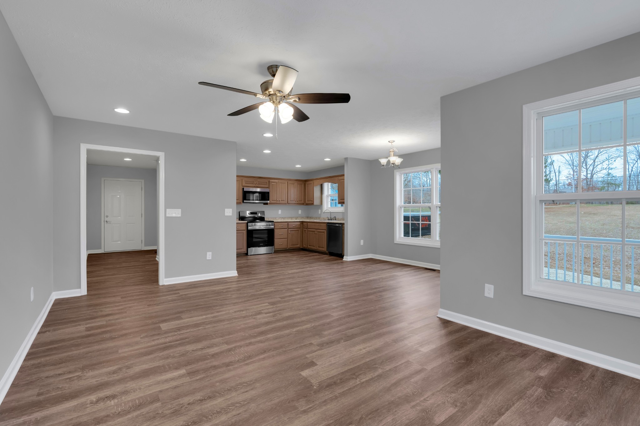 1332 Carter Blake Road Tullahoma, TN 37388 - Photo 7 of 31 a view of a big room with wooden floor and a kitchen