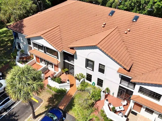 a view of a sign board with buildings in the background