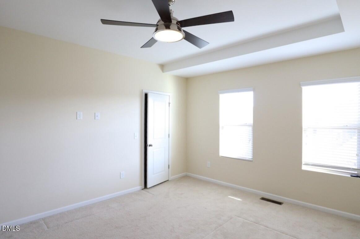 1517 Crafton Way Raleigh, NC 27607 - Photo 15 of 28 an empty room with windows and fan