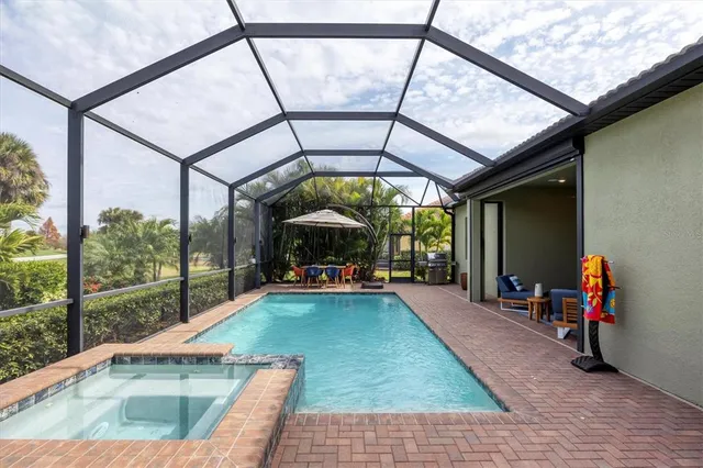 a kitchen with stainless steel appliances kitchen island granite countertop a table chairs stove and refrigerator
