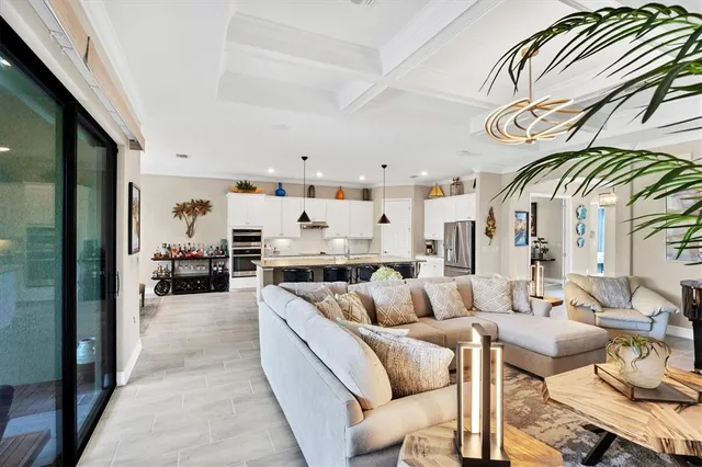 a bedroom with a large bed and a chandelier