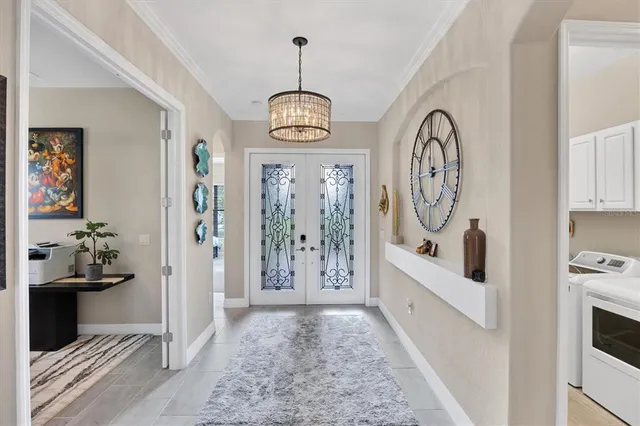 a living room with furniture flat screen tv and large window