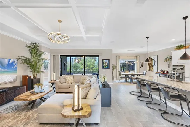 a living room with furniture a chandelier and a table