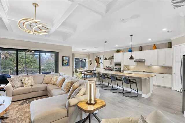 a living room with furniture and a floor to ceiling window