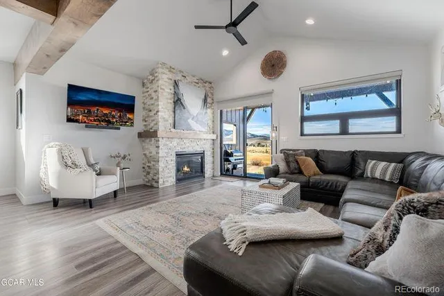 a living room with furniture a fireplace and a flat screen tv