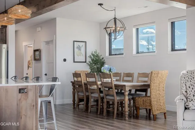 a view of a dining room with furniture and wooden floor
