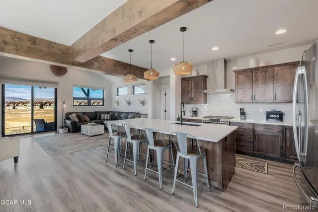a large kitchen with a table and chairs